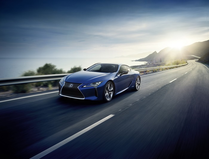 Blue Lexus LC 500h driving on coastal road