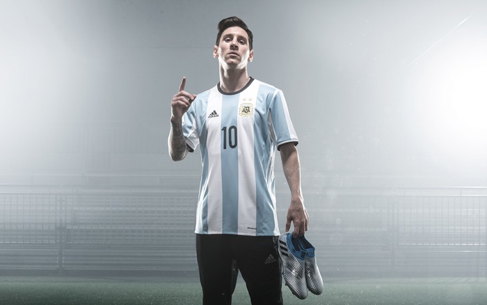 Lionel Messi in Argentina Jersey Holding Soccer Cleats