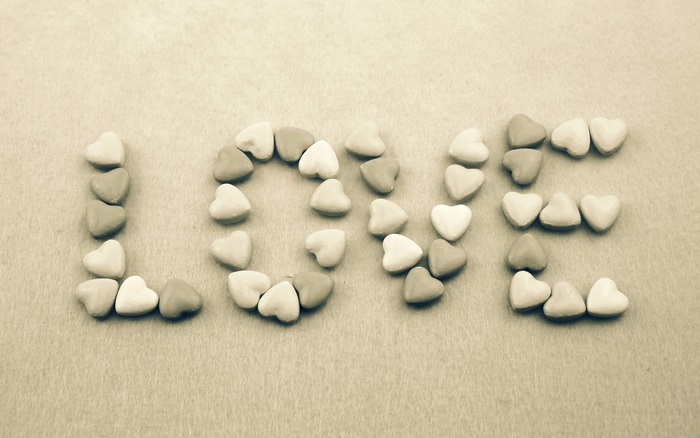 The word LOVE spelled with heart candies