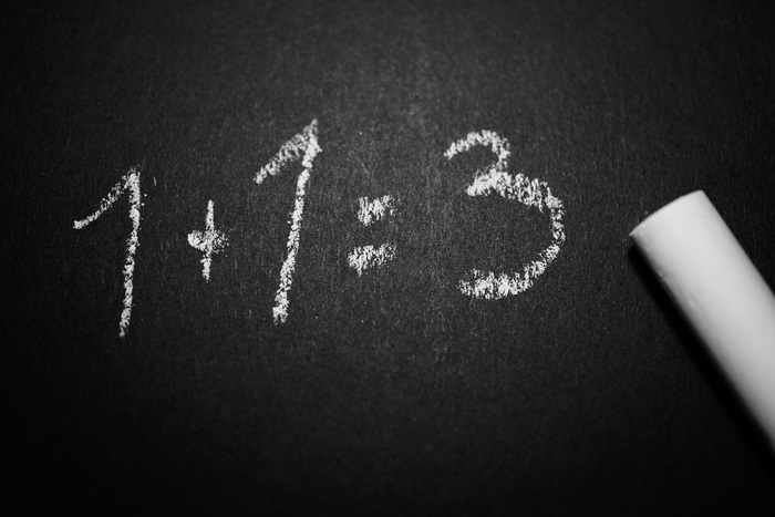 1+1=3 equation on blackboard with chalk