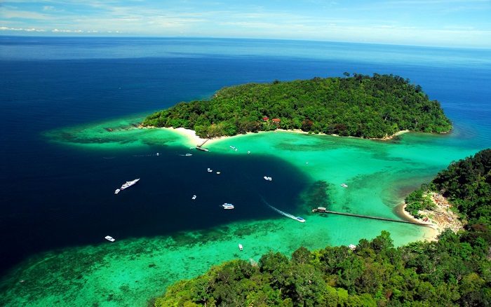 Aerial view of a tropical island with clear turquoise water