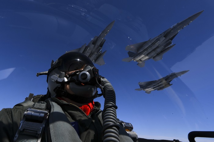 4K Fighter Pilot with Jet Squadron in Blue Sky
