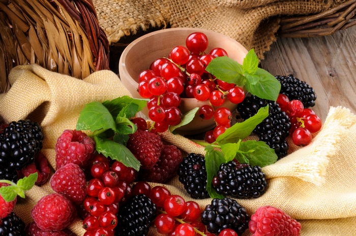 Berries in a basket with burlap and wood