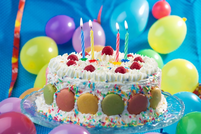 Birthday cake with candles and balloons