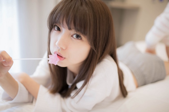 Asian girl with lollipop in mouth, 4K