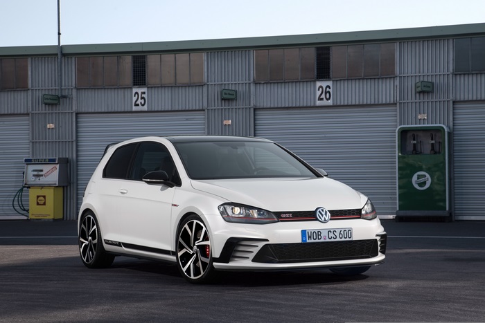 White Volkswagen Golf GTI parked at a garage
