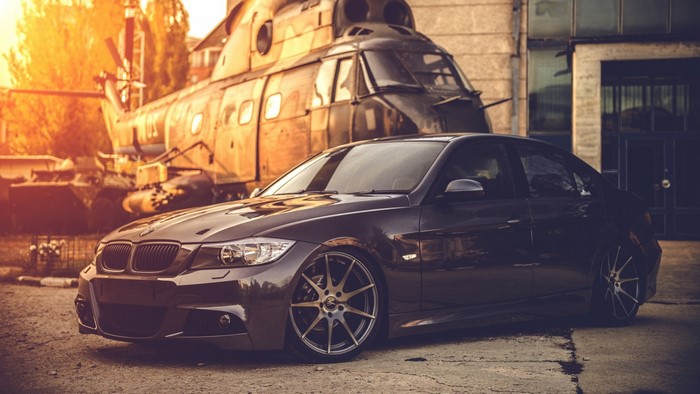 BMW E90 car with military helicopter in background