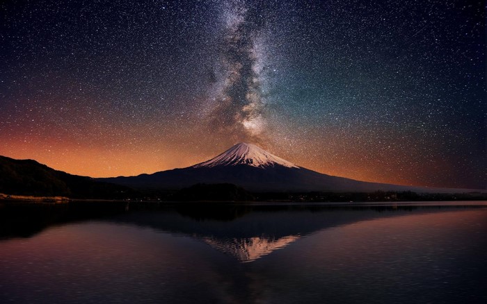 Mount Fuji under the Milky Way reflected in a lake