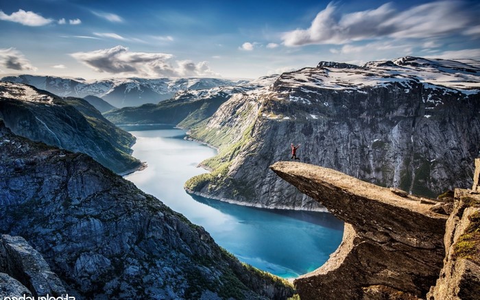 Person jumping on Trolltunga rock in Norway