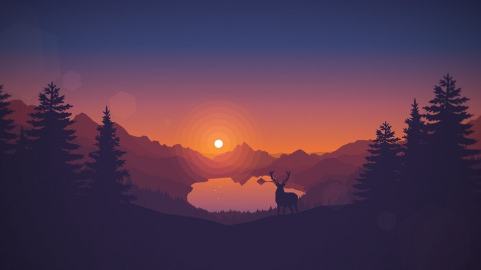 Deer silhouette by lake during sunset with mountains and pine trees
