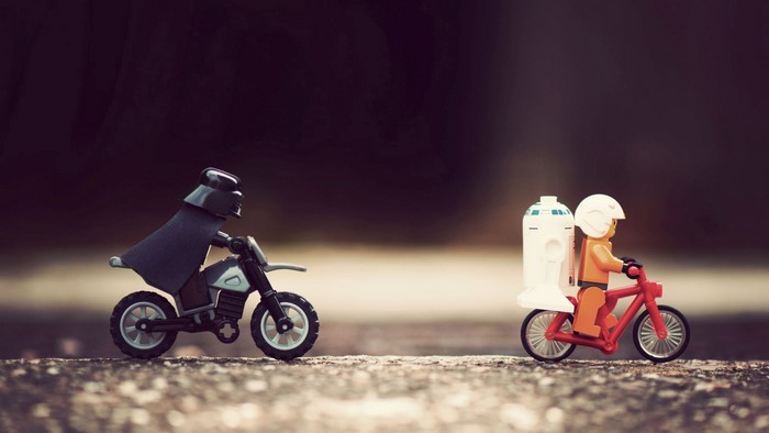 Darth Vader and R2-D2 Lego figures on bikes