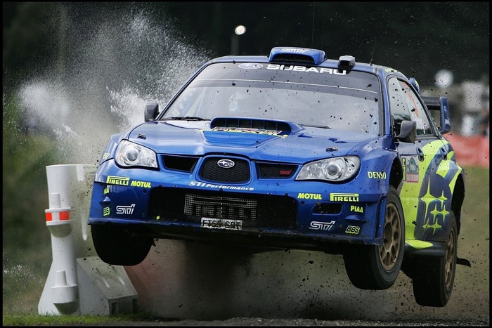 Blue Subaru Impreza WRX STI rally car jumping