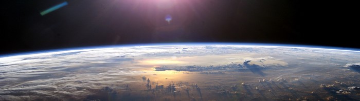 Earth from space with sun glare
