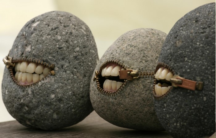 Three rocks with zippers and teeth