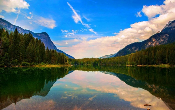 Lake reflection with mountains and forest