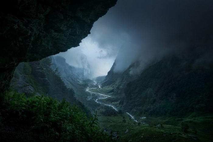 Misty valley with a winding river and mountains