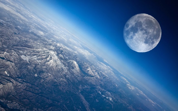 Moon Over Snowy Mountain Range from Space