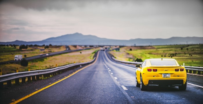 Yellow Chevrolet Camaro on a highway