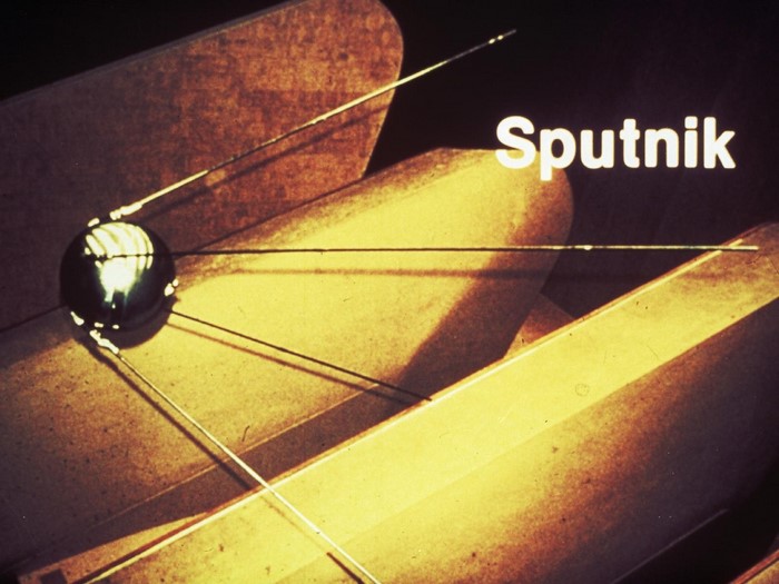 Sputnik satellite in front of abstract shapes