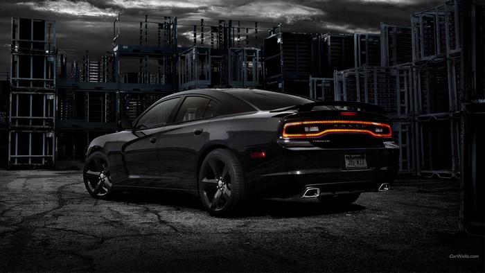 Black Dodge Charger in industrial setting