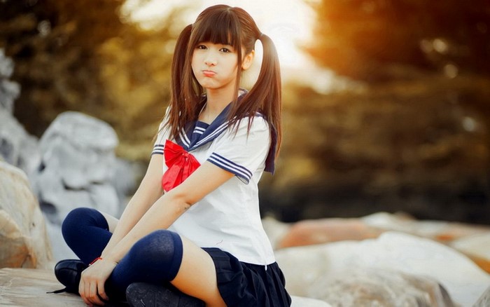 Asian girl in school uniform with pigtails