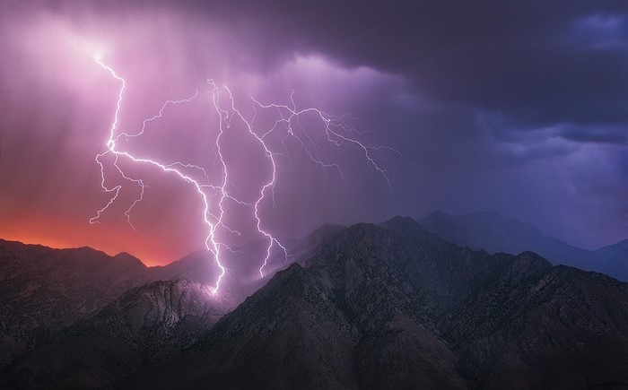 Lightning strikes mountains during a storm in Death Valley, California