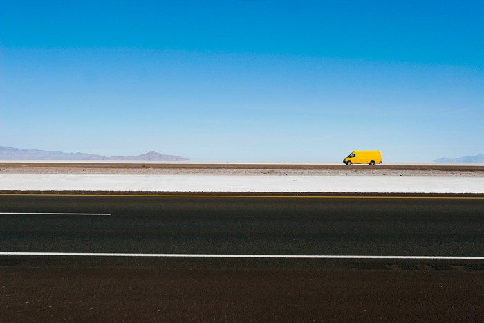 Yellow van on a salt flat road