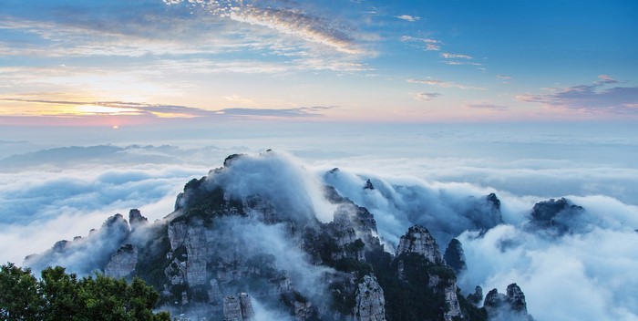 Sunrise over misty mountains in Zhangjiajie National Forest Park, China