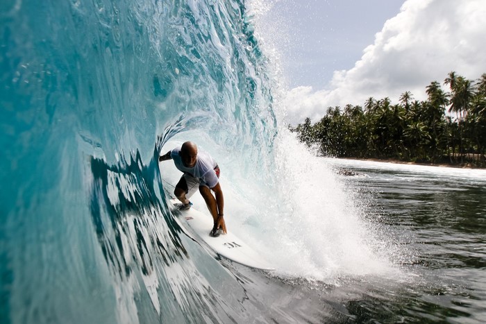 Surfer riding a wave inside a barrel