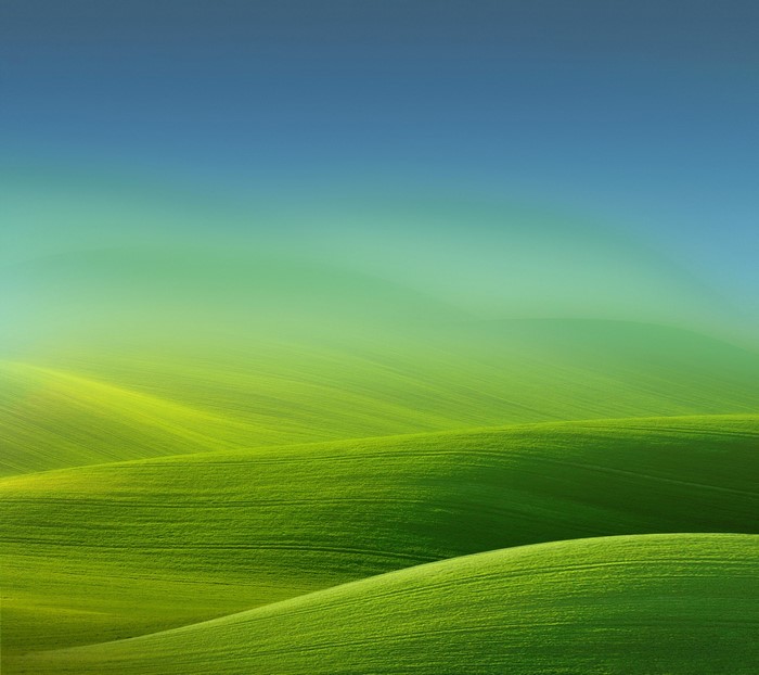 Green rolling hills with a blue sky gradient