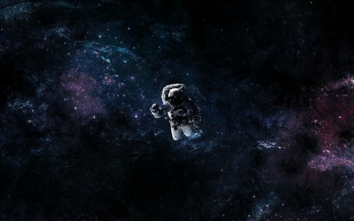 Astronaut floating in a colorful nebula