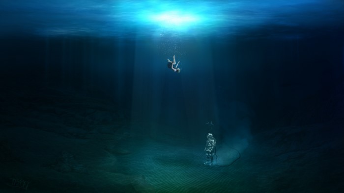 Person falling underwater near a diver