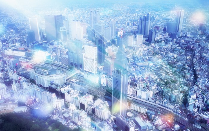 Aerial view of a futuristic city skyline with glowing lights