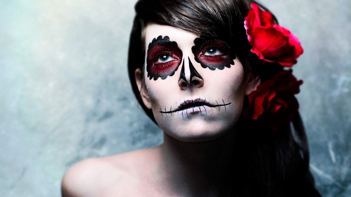 Woman with Sugar Skull Makeup and Red Roses