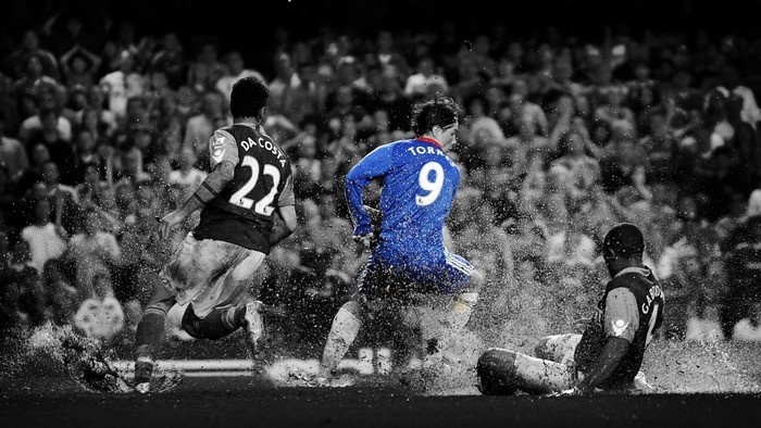 Fernando Torres and teammates playing soccer in mud