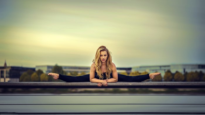 Woman doing splits on a bench