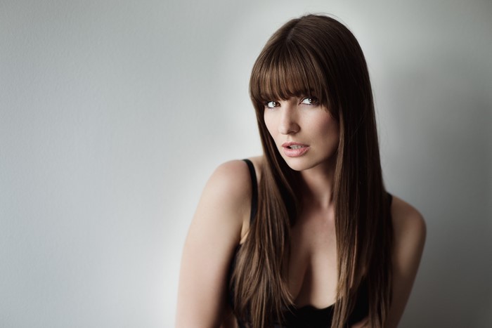 Woman with long brown hair and bangs