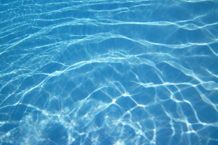 Underwater swimming pool tiles with light reflections
