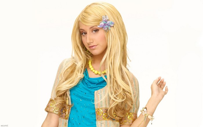 Ashley Tisdale with blonde hair and butterfly hair clip
