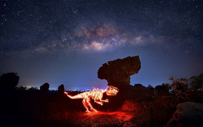 Dinosaur skeleton light painting under the Milky Way