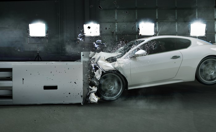 White car crashing into a barrier