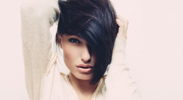 Brunette woman with dark hair and light sweater