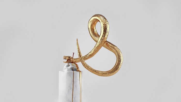 Gold snake and skull sculpture with marble base