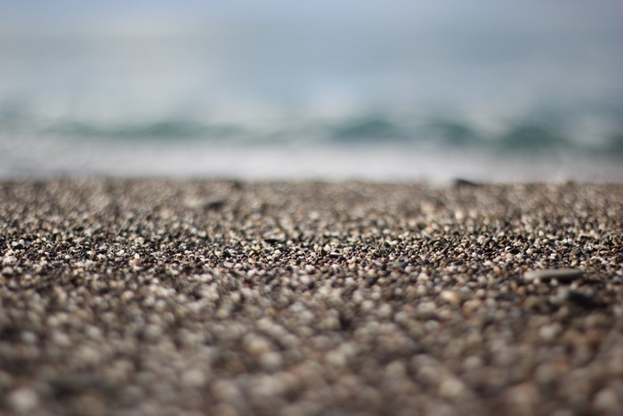 Beach pebbles and blurred ocean waves