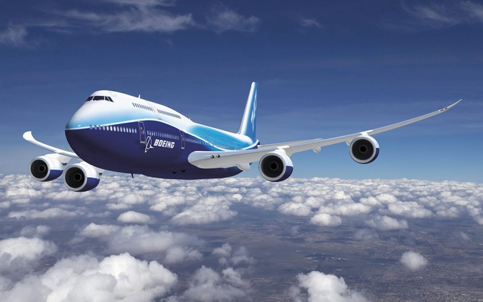 Boeing 747 passenger aircraft flying above clouds
