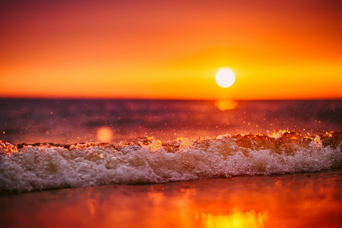 Sunset Over Gentle Ocean Waves on the Beach