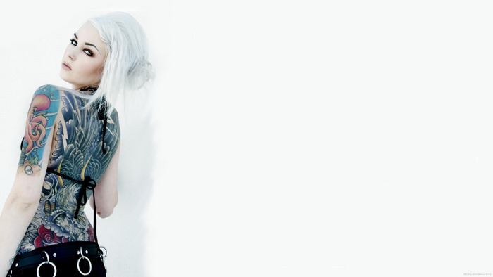 Woman with white hair and full body tattoos