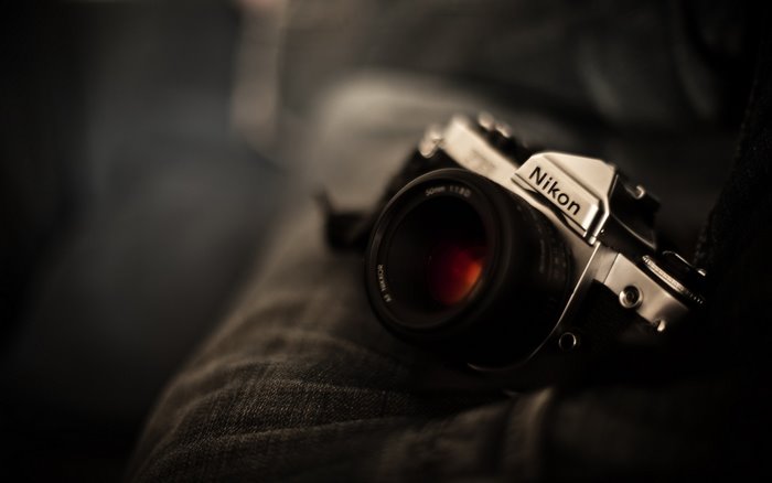 Nikon camera with 50mm lens on denim
