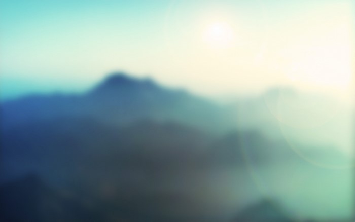 Blurred mountains with sun rays