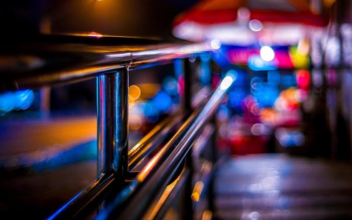 Bokeh steel railing at night with colorful lights